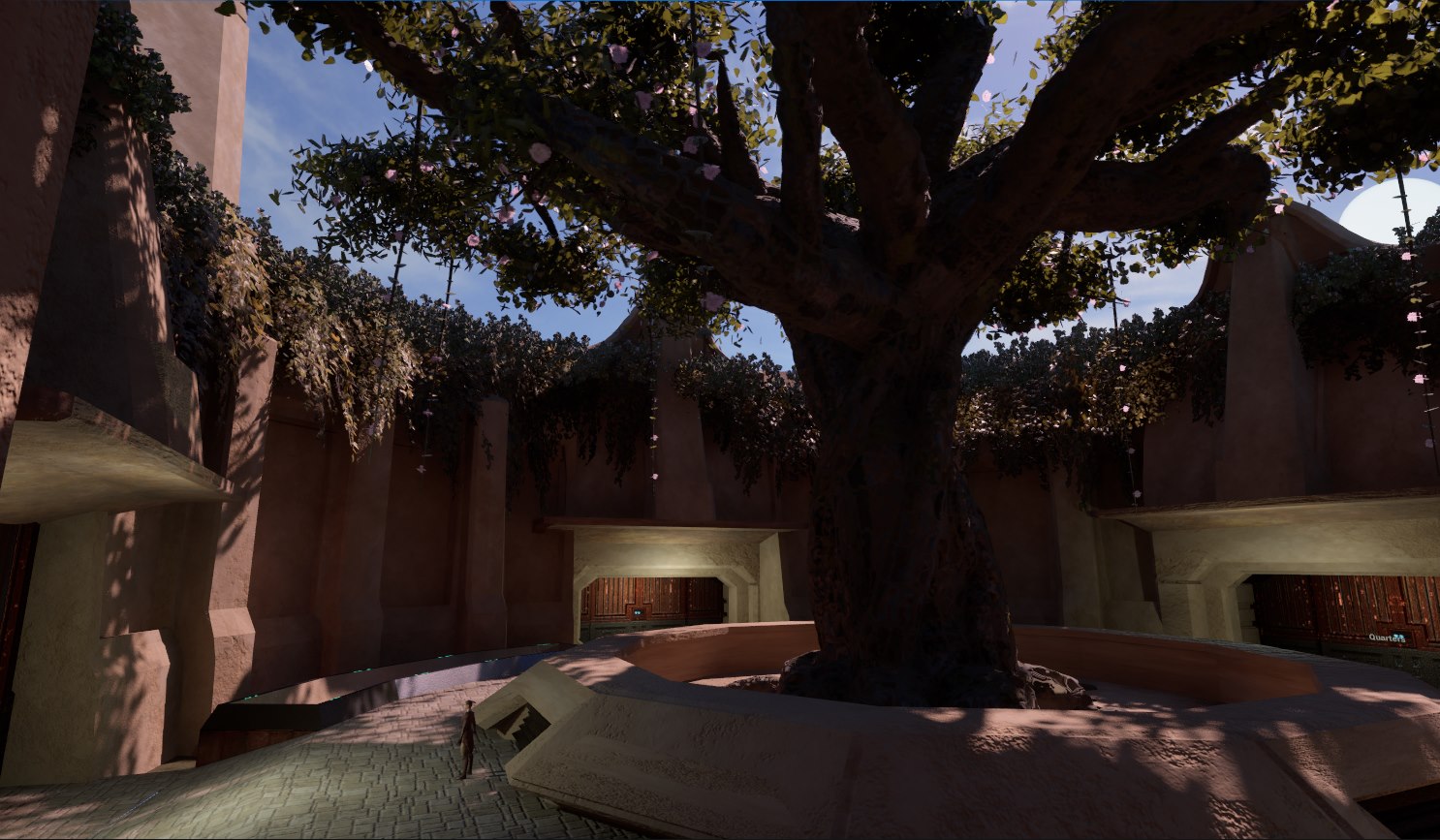 Finished Enclave courtyard with its central tree, final materials, foliage, and lighting.